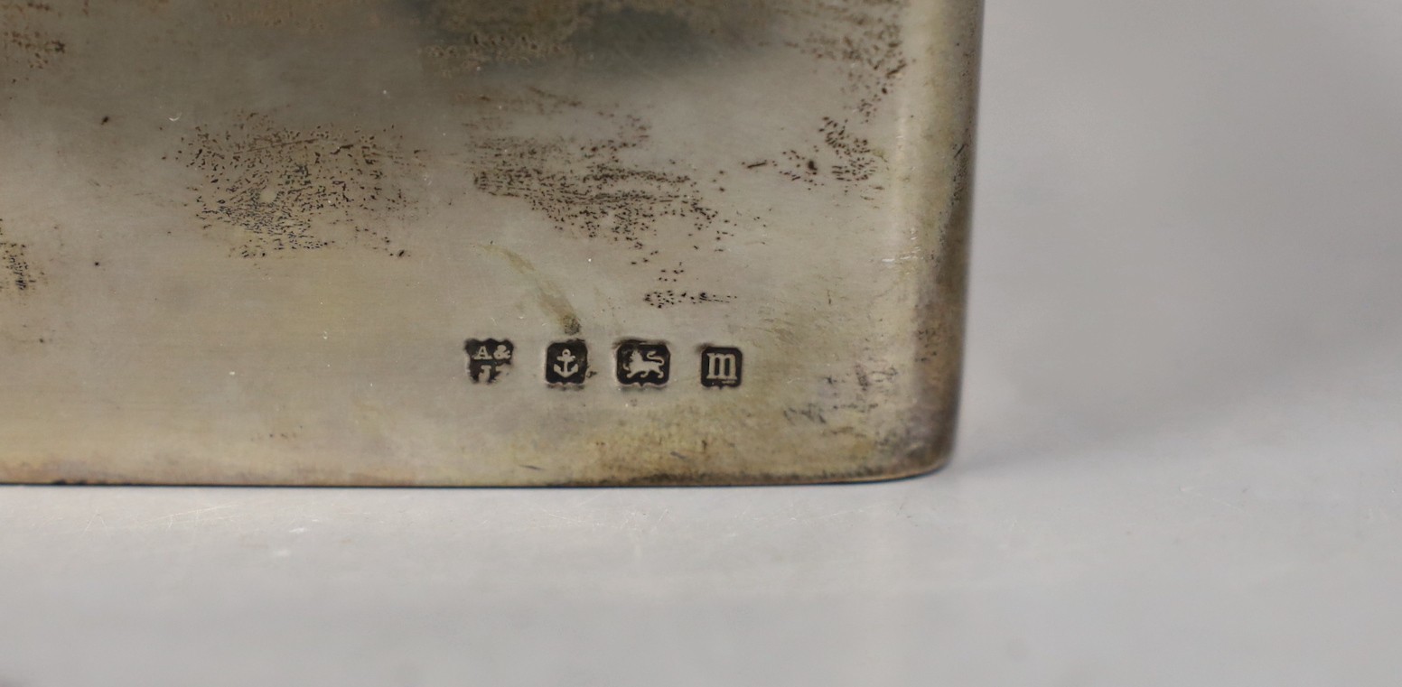 A George V silver mounted rectangular cigarette box, Birmingham, 1911, 17.2cm and an engraved white metal small tray.